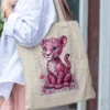 Woman carrying a natural cotton tote bag with a pink leopard cub illustration, part of LIVNT's WildBloom collection