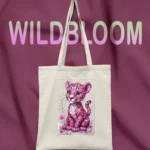 Canvas tote bag with pink leopard cub print and LIVNT logo, hanging against purple fabric background