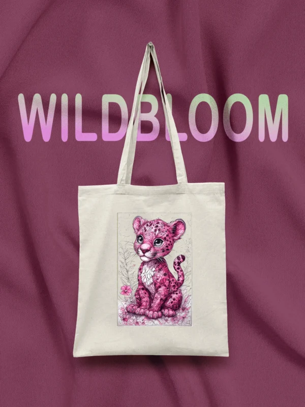 Canvas tote bag with pink leopard cub print and LIVNT logo, hanging against purple fabric background