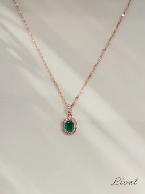 LIVNT Emerald Glow Necklace in 18K rose gold with emerald-green cubic zirconia and anti-tarnish finish.
