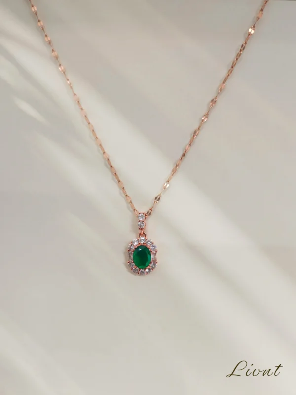 LIVNT Emerald Glow Necklace in 18K rose gold with emerald-green cubic zirconia and anti-tarnish finish.