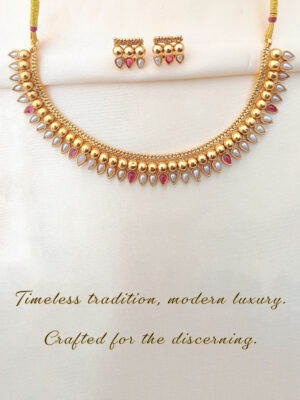 Promotional poster for LIVNT Ruby & Pearl Heritage Necklace with text “Timeless tradition, modern luxury. Crafted for the discerning.” on textured beige background