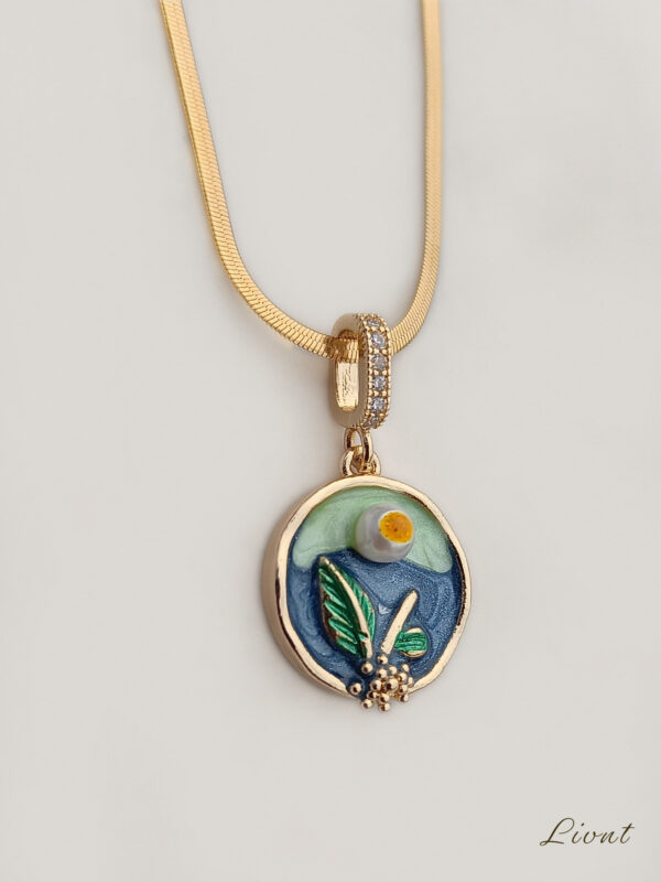 LIVNT Verdant Circle necklace featuring 18K gold plated pendant with hand-painted blue and green enamel botanical design on flat chain