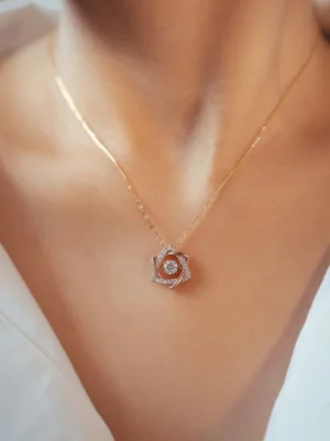 Minimalist gold chain necklace with a diamond-studded floral pendant from LIVNT – symbolic luxury streetwear jewelry for modern expression.