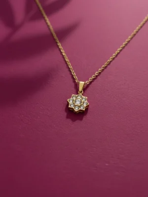 Close-up of the LIVNT Zen Bloom 18K gold anti-tarnish necklace pendant, showing the detailed crystal minimalist flower pendant design.