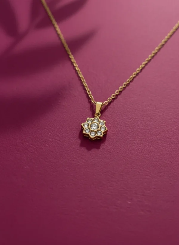 Close-up of the LIVNT Zen Bloom 18K gold anti-tarnish necklace pendant, showing the detailed crystal minimalist flower pendant design.