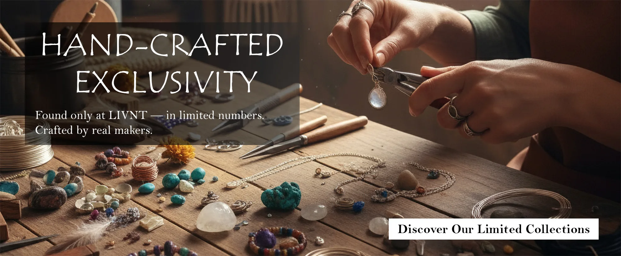 An artisan's hands carefully crafting a silver earring with a round moonstone charm on a rustic wooden workbench filled with turquoise beads, gemstones, and jewelry-making tools.