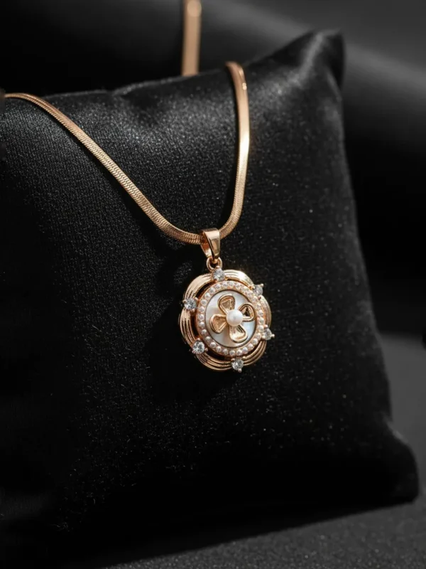 Close-up of LIVNT Petal Whorl Antitarnish Necklace on black silk background, highlighting gold tones, pearl center, and sparkling stones.