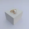 An angled, three-quarter view of the Orb Ring, showcasing the pearl's beautiful luster and the delicate structure of the gold setting on a white background.
