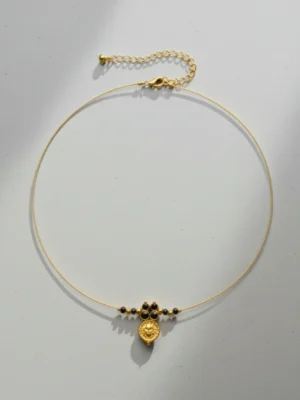 Full view of the Lakshmi Mangalmaya Invisible Chain necklace, showing the delicate gold chain, central pendant, and adjustable lobster clasp on a light grey background.