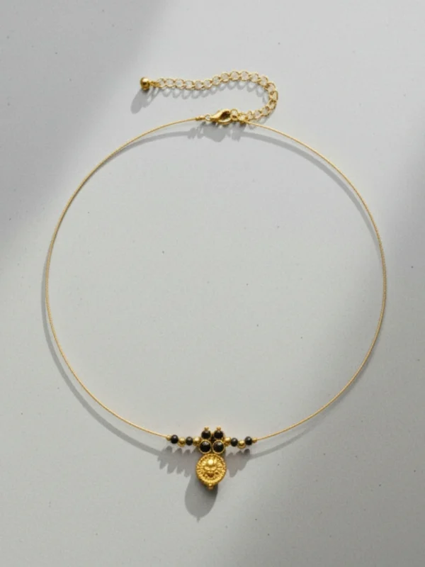 Full view of the Lakshmi Mangalmaya Invisible Chain necklace, showing the delicate gold chain, central pendant, and adjustable lobster clasp on a light grey background.