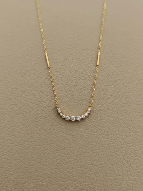 Starlit Curve Necklace – minimalist gold chain with crystal arc design by LIVNT, inspired by starlight elegance and modern symbolism