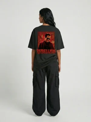Woman wearing Akshaye Khanna Dhurandhar inspired oversized black t-shirt with rebellion back print artwork in heavyweight cotton streetwear style