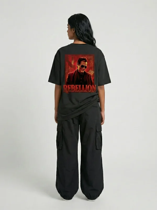 Woman wearing Akshaye Khanna Dhurandhar inspired oversized black t-shirt with rebellion back print artwork in heavyweight cotton streetwear style