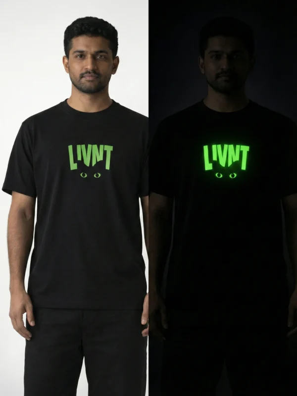 Day and night comparison of LIVNT glow-in-the-dark cat t-shirt on male model